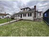 Two-story home with a ramp leading to the front door, red shutters, and a chimney against a cloudy sky at 805 W 3Rd St, Alexandria, IN 46001
