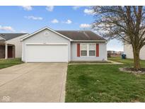 Charming one-story home featuring a well-maintained lawn, attached garage, and inviting curb appeal at 8452 Abbey Dell Dr, Camby, IN 46113
