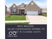 Charming single-story brick home with a well-manicured lawn and two-car garage at 981 Mound St, Bargersville, IN 46106