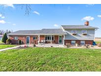 Charming two-story home with a landscaped yard, brick accents, and a welcoming front porch at 139 W Jefferson St, Jamestown, IN 46147