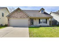 Charming single-story home featuring a brick accent, attached garage, and well-maintained front lawn at 14938 Silver Thorne Way, Carmel, IN 46033