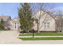Charming brick home with well-maintained lawn, mature trees, and manicured landscaping at 15254 Kampen Cir, Carmel, IN 46033