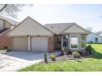 Charming home with a two-car garage, tidy landscaping, and great curb appeal at 3013 Crimson W Ct # 42, Carmel, IN 46033
