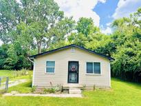 Charming single-story home with tidy lawn, mature trees and decorative front door at 3201 N Hawthorne Ln, Indianapolis, IN 46218
