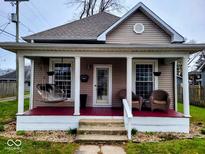 Inviting front porch with rocking chairs, swing, and a charming entrance to the home at 515 Powell St, Lebanon, IN 46052