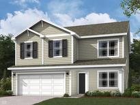 Charming two-story home with attached garage and inviting curb appeal on a beautifully landscaped lawn at 6011 Card Blvd, Indianapolis, IN 46221