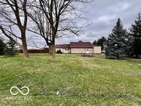 A view of the spacious backyard featuring a glimpse of the house, showing outdoor space at 7154 S 325 W, Jamestown, IN 46147