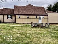 View of the backyard with a patio set, showing the exterior of the house at 7154 S 325 W, Jamestown, IN 46147