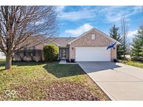 Charming brick home with a two-car garage and long driveway on a sunny day at 7260 Blue Ridge Dr, Noblesville, IN 46062