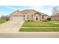 Charming brick home featuring a two-car garage and beautifully landscaped front yard at 1120 Constitution Dr, Edinburgh, IN 46124