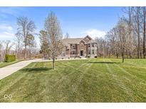 Beautiful brick two-story home featuring a well-manicured lawn and professional landscaping at 1527 Canyon Oak Ln, Columbus, IN 47201