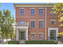 Charming brick townhouse with a covered front porch and well-maintained landscaping at 2183 Glebe St, Carmel, IN 46032