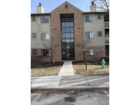 A three-story tan and brick building with dark window and door frames and minimal landscaping at 4291 Village Parkway W Cir # 3, Indianapolis, IN 46254