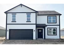 Two-story home featuring black accents and an attached two-car garage at 5210 Cartland Dr, Indianapolis, IN 46239