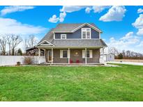 Charming two-story home featuring a covered porch and a well-maintained lawn at 5371 Lue Ann Ln, Mooresville, IN 46158