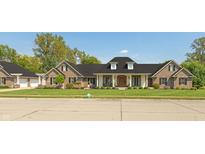 Beautiful brick home with manicured lawn, black shutters, and a welcoming front entrance at 6017 Quail Creek Blvd, Indianapolis, IN 46237