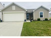 Charming single-story home with a well-maintained lawn and a two car attached garage at 6331 Enclave Blvd, Greenwood, IN 46143