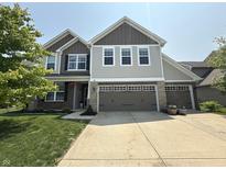 Charming two-story home with a three-car garage and well-manicured lawn, providing great curb appeal at 6345 Meadowview Dr, Whitestown, IN 46075