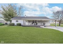 Charming single-story home featuring vinyl siding, covered porch, and well-maintained lawn at 654 Park Dr, Greenwood, IN 46143