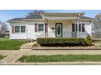 Charming home featuring a covered front porch, neat landscaping, and classic architectural details at 858 E Berwyn St, Indianapolis, IN 46203