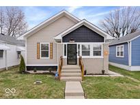 Charming bungalow with tidy landscaping, modern paint scheme and welcoming front steps at 1331 N Grant Ave, Indianapolis, IN 46201