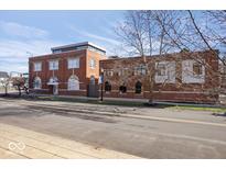 Brick building featuring an inviting front entrance with arched windows, plus professionally landscaped grounds at 1529 N Alabama N St # B, Indianapolis, IN 46202