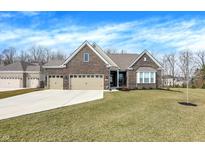 Charming brick home with a well-manicured lawn, three car garage, and beautiful curb appeal at 16075 Cobbs Crk Ln, Noblesville, IN 46060