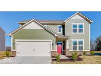Charming two-story home with a modern design, green siding, and a two-car garage on a sunny day at 226 Ambassador Dr, Pittsboro, IN 46167