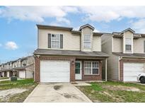 Charming townhome with brick accents and a one-car garage, perfect for comfortable suburban living at 2911 Percheron Ln, Indianapolis, IN 46227