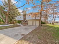 Charming split-level home with a two-car garage and mature trees in a suburban neighborhood at 321 Pleasantview Dr, Greenwood, IN 46142