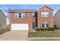 Charming two-story brick home with blue shutters, a well-maintained lawn, and a two-car garage at 380 Winterset Way, Greenwood, IN 46143