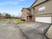 Inviting townhome with a two-car garage, brick accents, and well-maintained landscaping at 4283 Washington Blvd, Plainfield, IN 46168