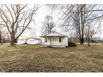 Inviting single-story home with covered front porch situated on a large lot with mature trees at 4355 W 450 S, Columbus, IN 47201