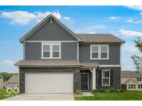 Beautiful two-story home featuring a brick and vinyl exterior with an attached two car garage and manicured lawn at 4739 E Shadowbrook Dr, Camby, IN 46113