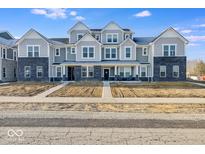 New construction townhome featuring gray siding, black brick, and covered porches in a modern style at 5771 Cr W 750 N, McCordsville, IN 46055
