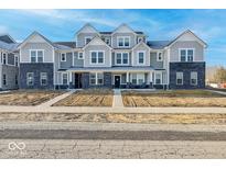 Attractive townhome with gray siding, black brick accents, and inviting front porches at 5777 Cr W 750 N, McCordsville, IN 46055