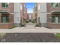 Colorful condo building featuring a well-maintained walkway and manicured landscaping, creating an inviting entrance at 622 E 10Th St # 206, Indianapolis, IN 46202