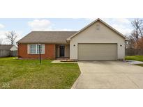 Charming single-story home featuring a brick facade and attached two-car garage at 6731 Thistleridge Ct, Indianapolis, IN 46221