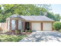 Charming brick home with a two-car garage and well-maintained landscaping in a suburban neighborhood at 6767 Colony Pointe South Dr, Indianapolis, IN 46250