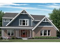 Charming two-story home featuring a brick facade, inviting front porch, and gable roof design at 6887 Oakdale Ln, Avon, IN 46123