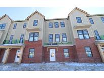 New multi-Gathering home with brick facade, modern windows, and wood accents under construction at 7085 Pate Hollow Dr, Brownsburg, IN 46112