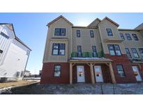 New townhouse with brick facade, large windows, and unfinished siding at 7093 Pate Hollow Dr, Brownsburg, IN 46112