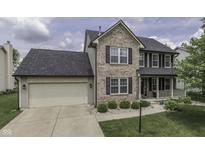 Charming two-story home with brick accents, black shutters, and a well-maintained front yard at 7448 Giroud Dr, Indianapolis, IN 46259