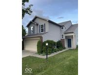 Charming two-story home with a two-car garage and a well-maintained lawn at 8033 Lake Tree Cir, Indianapolis, IN 46217