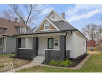 Beautiful home showcasing a covered front porch, fresh landscaping, and inviting curb appeal at 843 N Oxford St, Indianapolis, IN 46201