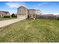 Charming two-story home with a large front yard and attached two-car garage at 912 Springside Ct, Greenfield, IN 46140