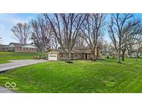 Charming single-story home featuring a well-maintained lawn, attached garage and beautiful landscaping at 9715 Mallery Dr, Noblesville, IN 46060