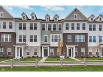 Beautiful new construction townhomes with a mix of brick and siding, with well-manicured lawns at 14562 Hanford Ln, Carmel, IN 46074