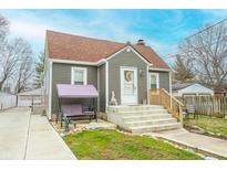 Charming exterior showcasing gray siding, and a cozy front porch swing and steps at 15 N Fleming St, Indianapolis, IN 46222