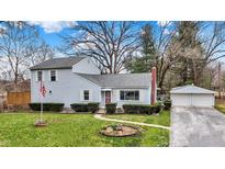 Charming two-story home with well-maintained lawn, complemented by a detached two car garage and mature trees at 207 E Ohio St, Mooresville, IN 46158